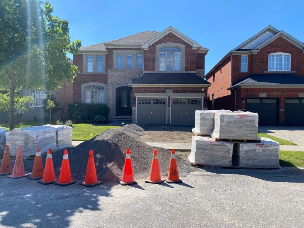 Interlocking materials displayed outside a driveway before the installation process