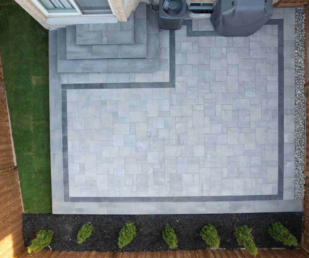 Drone-View-Grey-Interlocking-Patio-with-Cedar-Bushes-In-Guelph
