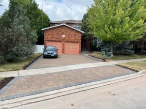 Interlocking driveway that includes a sidewalk separating the driveway.