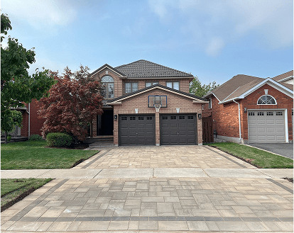 Property exemplifying interlocking paver stone work on a medium-sized driveway