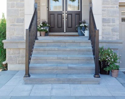 A standard-sized 5 step front porch with a small platform exemplifying paver stone work on a medium porch