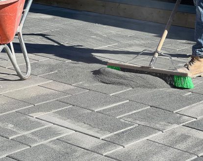 Paver stones being treated with a new layer of polymeric sand on top, exemplifying Pressure Wash and New Polymeric Sand services