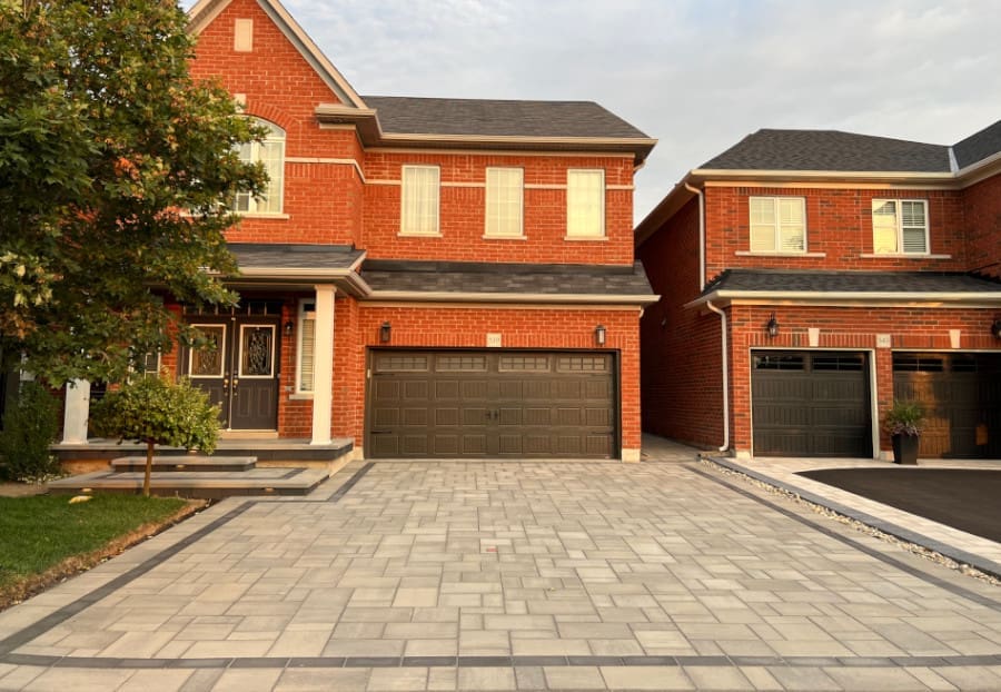 Residential property with intricate grey paver stone driveway