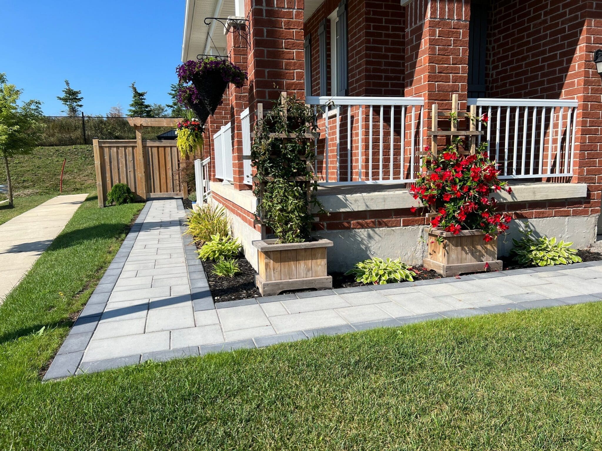 Interlocking walkway leading to a front entrance surrounded by landscaping in Mississauga.